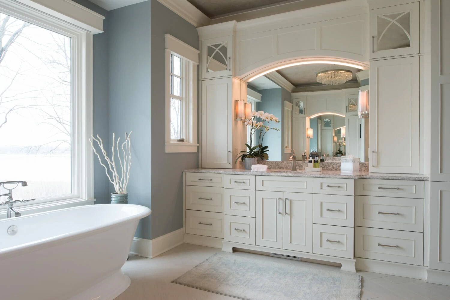 Classic white bathroom vanity with two linen towers and undercabinet lightning