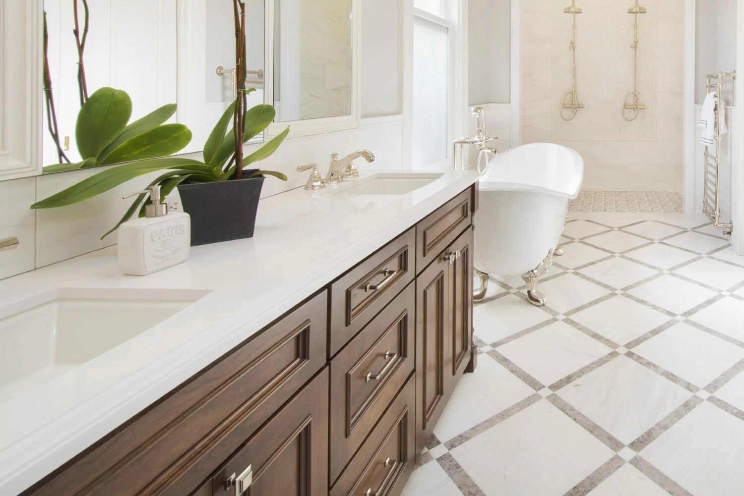 A bathroom vanity in wood tones with a quartz countertop