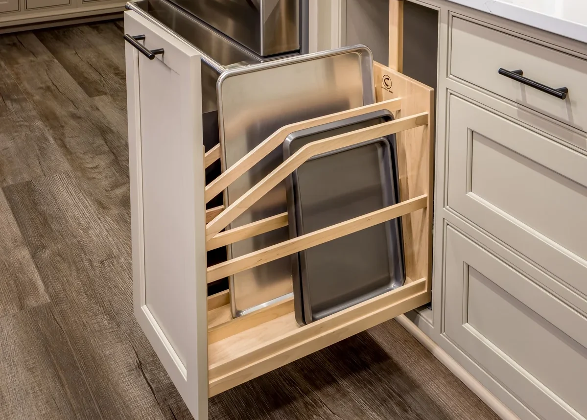 The Century Components cookie tray pull-out is seen in this image. It holds cookie trays, cutting boards, and other items in a vertical position.