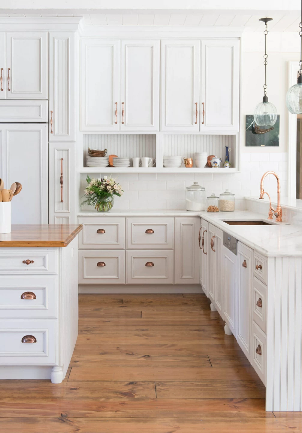 This home features historical characteristics with french victorian farmhouse accents, complete with rubbed bronze hardware pulls.